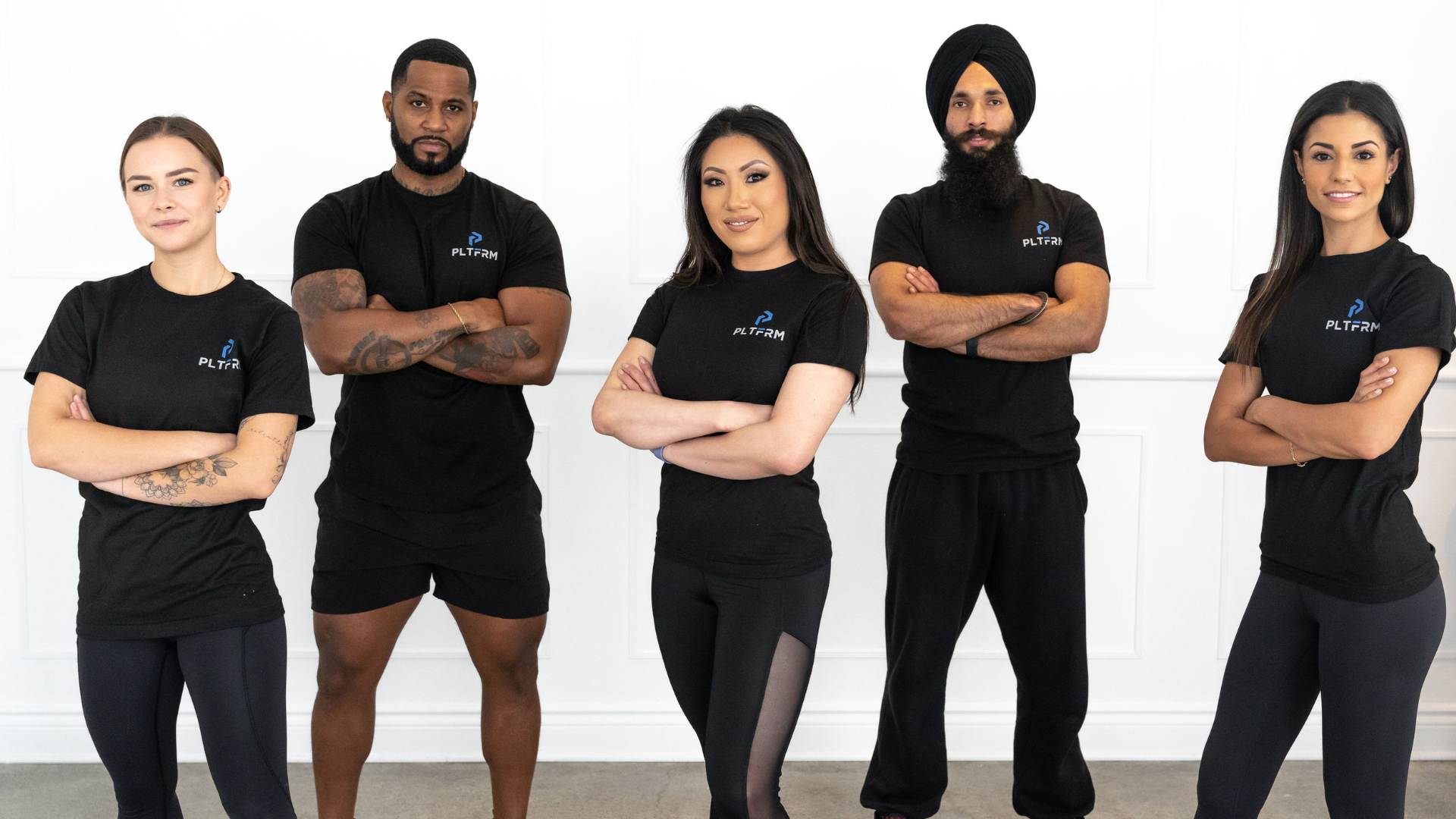 5 PLTFRM trainers standing with their arms crossed in t-shirts with the PLTFRM logo